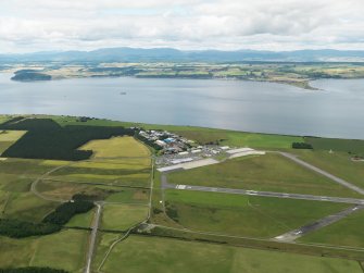 General oblique aerial view centred on part of the airfield with the technical site (terminal area), taken from the ESE.