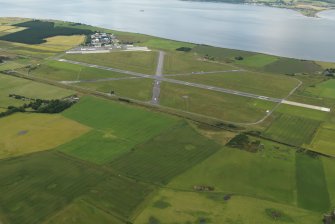 General oblique aerial view centred on the airfield, taken from the E.
