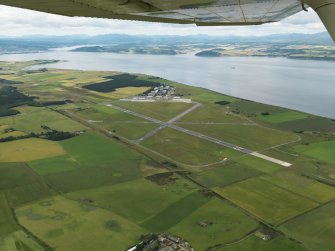 General oblique aerial view centred on the airfield, taken from the E.