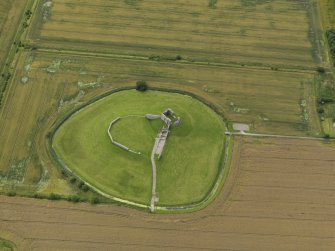 Oblique aerial view centred on the remains of the castle, taken from the NE.