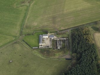 Oblique aerial view centred on the farmstead, taken from the WSW.