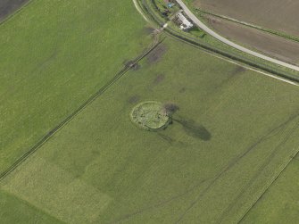 Oblique aerial view centred on the stone circle, taken from the E.