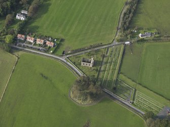 Oblique aerial view centred on the earthwork and church, taken from the SSE.