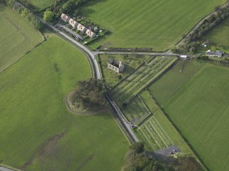 Oblique aerial view centred on the earthwork and church, taken from the ESE.