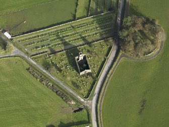 Oblique aerial view centred on the earthwork and church, taken from the WSW.