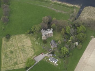 Oblique aerial view centred on the castle with the custodian's house adjacent, taken from the S.