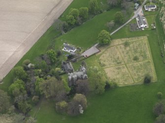 Oblique aerial view centred on the castle with the custodian's house adjacent, taken from the NNE.