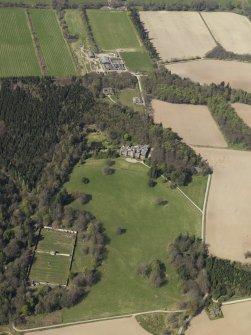Oblique aerial view of the country house with the walled garden adjacent, taken from the SSE.