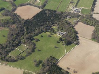 Oblique aerial view of the country house with the walled garden adjacent, taken from the ESE.