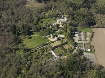 Oblique aerial view centred on the castle with the garden adjacent, taken from the SE.