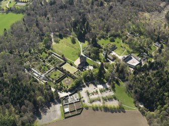 Oblique aerial view centred on the castle with the garden adjacent, taken from the NE.