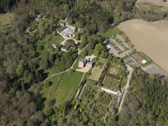 Oblique aerial view centred on the castle with the garden adjacent, taken from the SSE.