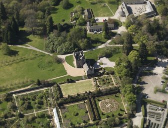 Oblique aerial view centred on the castle with the garden adjacent, taken from the E.