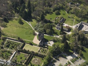 Oblique aerial view centred on the castle with the garden adjacent, taken from the ENE.