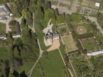 Oblique aerial view centred on the castle with the garden adjacent, taken from the SSW.