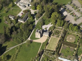 Oblique aerial view centred on the castle with the garden adjacent, taken from the S.
