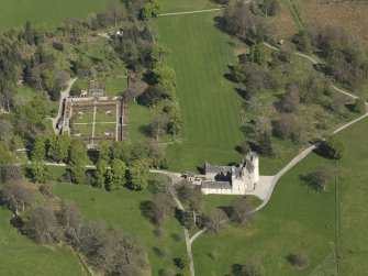 Oblique aerial view centred on the castle with the walled garden adjacent, taken from the WSW.
