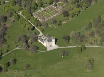 Oblique aerial view centred on the castle with the walled garden adjacent, taken from the SW.