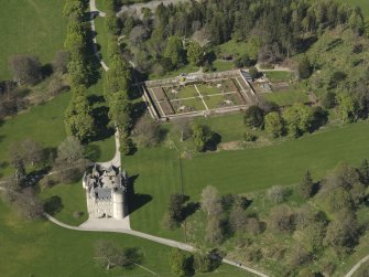 Oblique aerial view centred on the castle with the walled garden adjacent, taken from the S.