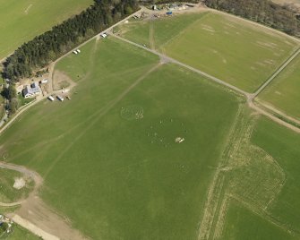 Oblique aerial view centred on the modern recumbent stone circle, taken from the NW.