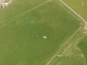 Oblique aerial view centred on the modern recumbent stone circle, taken from the N.