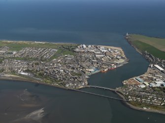 General oblique aerial view centred on the town with the road and rail bridges adjacent, taken from the W.