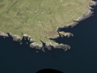 Oblique aerial view centred on the remains of the castle, burial vault and dovecot on Stroma, taken from the S.