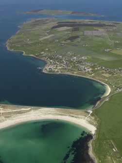 General oblique aerial view looking across Churchill Barrier No. 4 and Water Sound towards the village of Burray, taken from the SE.