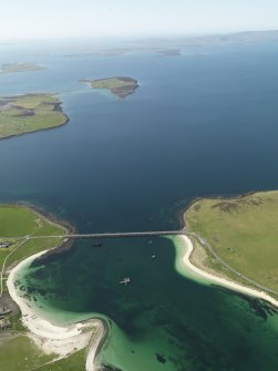 General oblique aerial view looking across Churchill Barrier no. 3 with Hunda, Flotta, Hoy and Scapa Flow beyond, taken from the WSW.