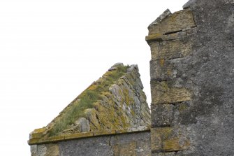 Detail of wallheads and skewputt at south west corner of the church