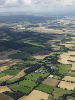 General oblique aerial view looking across the village of Forgandenny and Rossie House and along Strath Earn, taken from the ENE.