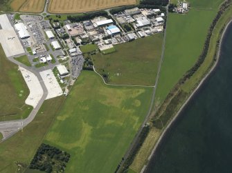 Oblique aerial view centred on the cropmarks of a possible enclosure at Easter Kerrowgair, taken from the NE.