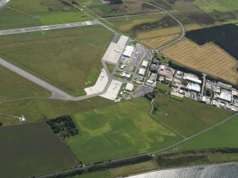 Oblique aerial view centred on the cropmarks of a possible enclosure at Easter Kerrowgair, taken from the NE.