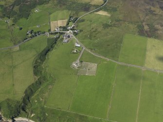 Oblique aerial view centered on the parish church and burial ground of Latheron, taken from the SE.