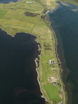General oblique aerial view centred on the excavations of Brodgar settlement with the Ring of Brodgar beyond, taken from the SSW.