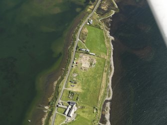 Oblique aerial view centred on the excavations of Brodgar settlement, taken from the NW.