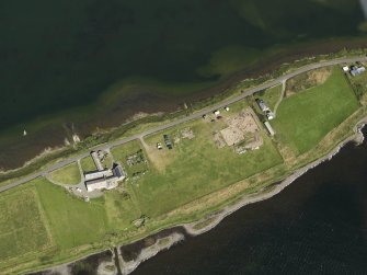 Oblique aerial view centred on the excavations of Brodgar settlement, taken from the SW.