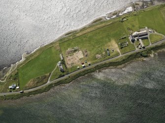 Oblique aerial view centred on the excavations of Brodgar settlement, taken from the NE.