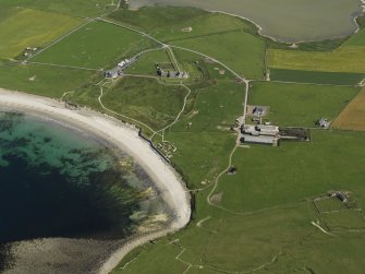 Oblique aerial view centred on the neolithic settlement at Skara Brae, Bay of Skaill, with Skaill House adjacent, taken from the W.