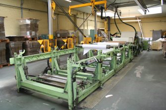 Paper sheeting machine in the finishing section (7) at Guardbridge Paper Mill, showing the reel handling equipment overhead and the dust extractors.