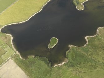 Oblique aerial view centred on the possible broch and chapel site, 'The Burrian', in the Loch of Wasbister, taken from the W.