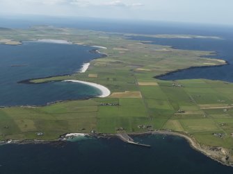 General oblique aerial view of the S end of Westray with Papa Westray to the NE, taken from the SE.