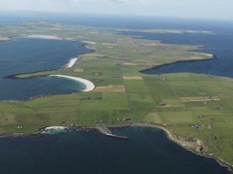 General oblique aerial view of the S end of Westray with Papa Westray to the NE, taken from the SE.