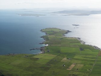 General oblique aerial view of the S end of Westray looking towards the Point of Huro, taken from the NE.