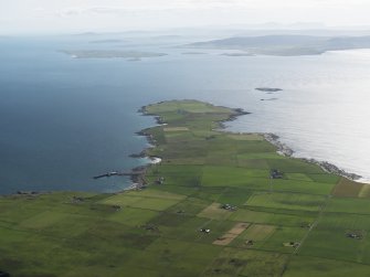 General oblique aerial view of the S end of Westray looking towards the Point of Huro, taken from the NE.