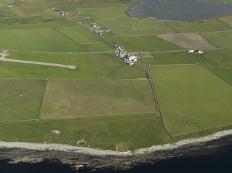 General oblique aerial view centred on Skaill farmstead with the neolithic buildings at the Knap of Howar in the foreground, taken from the NW.