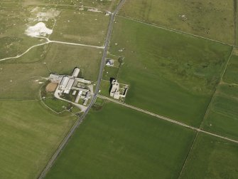 Oblique aerial view centred on the ruins of Noltland Castle with Noltland farmsteading adjacent, taken from the W.