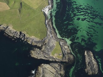 Oblique aerial view centred on the Knowe of Skea broch and the excavation of the cemetery, taken from the SW.