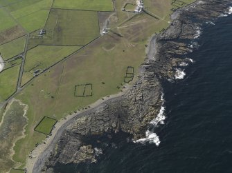 Oblique aerial view centred on the enclosures at Dennis Head with Dennis Head lighthouse adjacent, taken from the SSE.