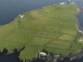 General oblique aerial view of Copinsay showing the lighthouse and field system, taken from the N.